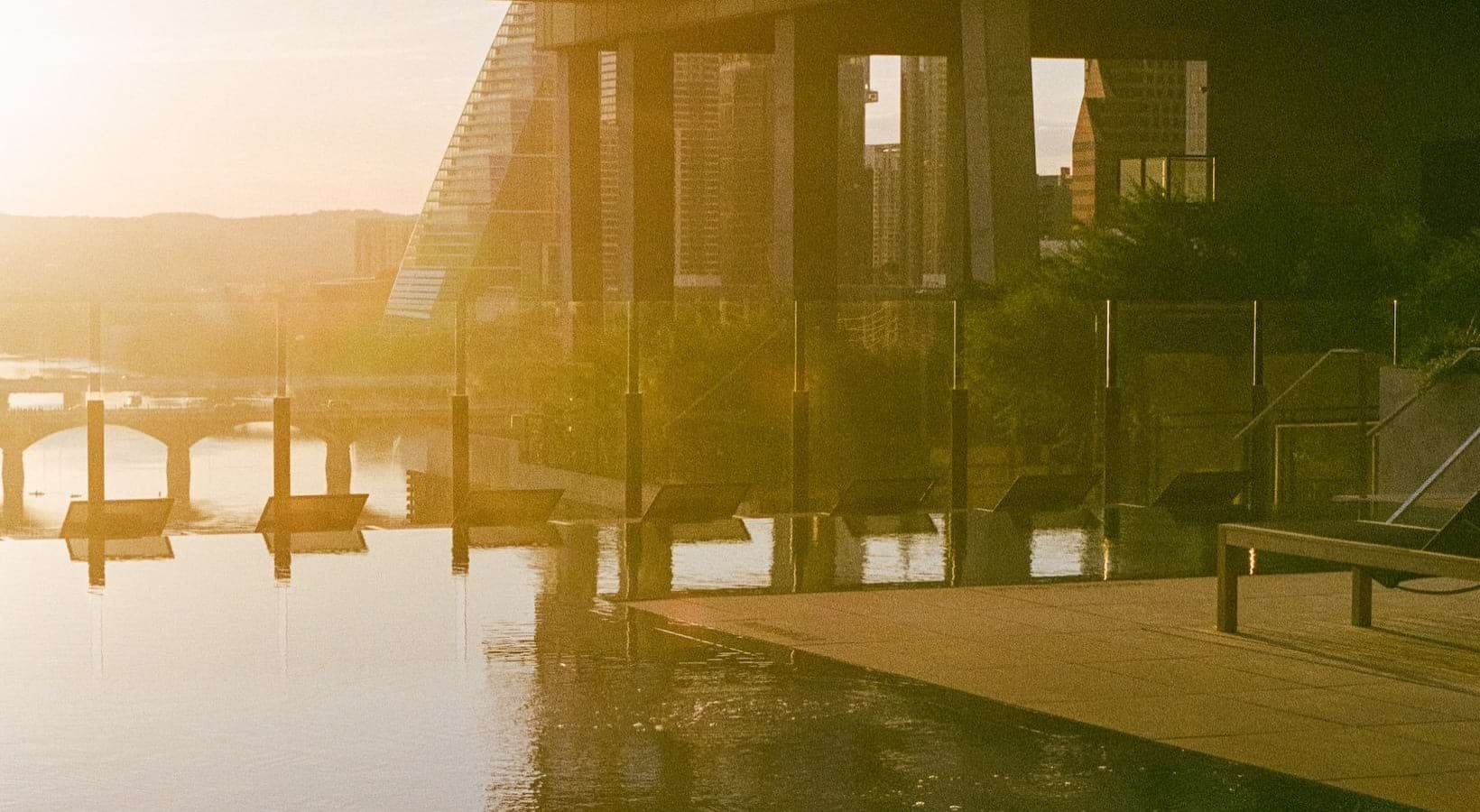 swimming pool with the sunset beaming across the water