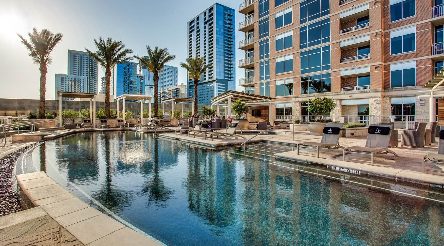 Resort-style swimming pool with sundeck at Ashton Austin apartments for rent in Austin