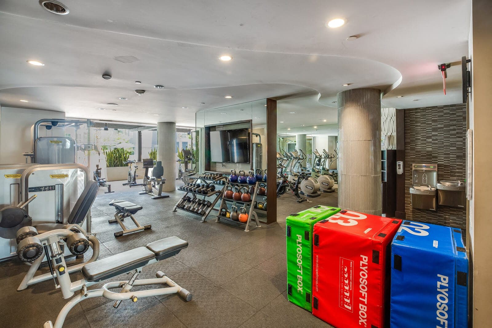 The fitness center is spacious and filled with natural light