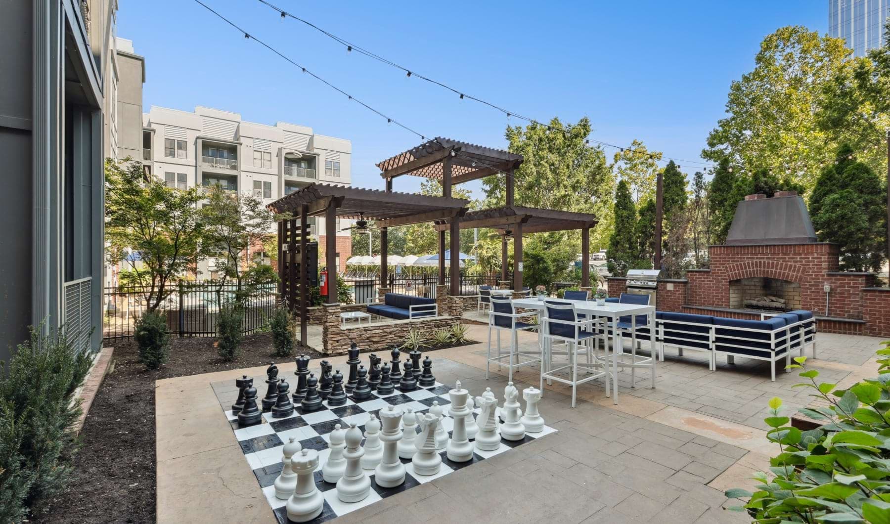 outdoor lounge with large chess board, seating and outdoor fireplace