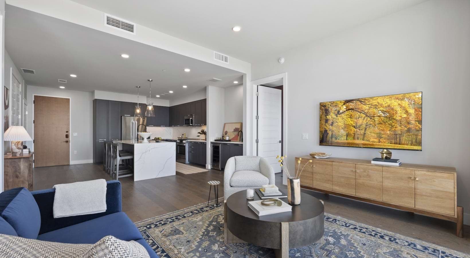 Spacious living room and kitchen with skyline views