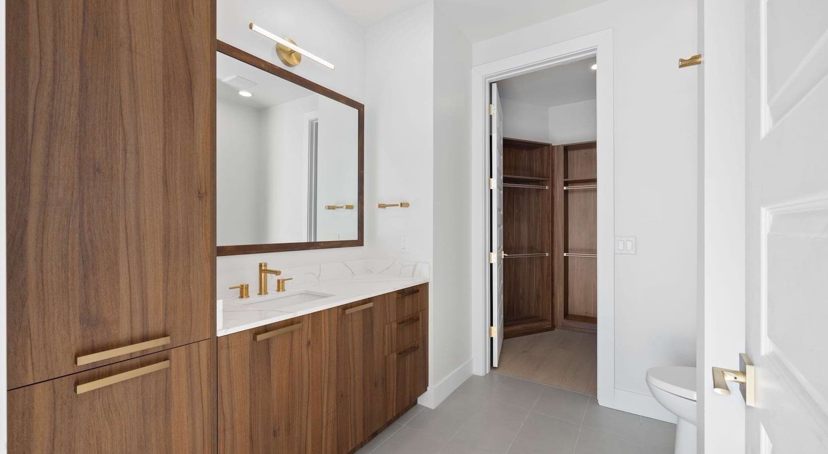 Bathroom with Walnut Cabinets with White Countertops