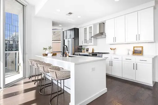 A modern kitchen with white cabinets and a large island.