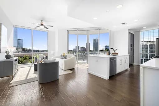 A modern living room with a large window overlooking the city.