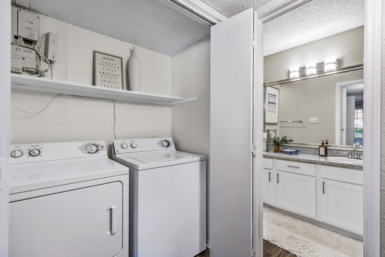 Laundry room with modern washers and dryers in The Georgian Apartments