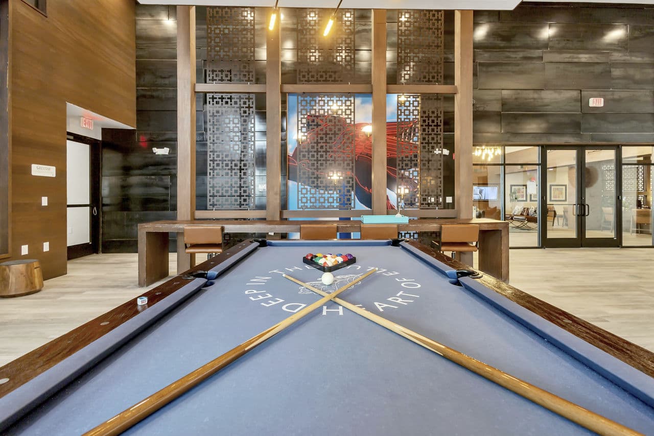 Modern game room with a pool table and decorative walls