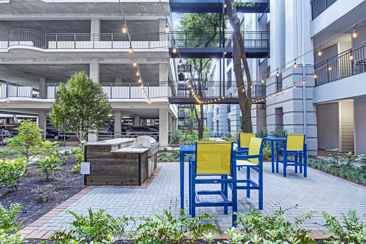 Grill area with modern seating at Riviera at West Village Apartments, a premier location for luxury living and outdoor entertaining