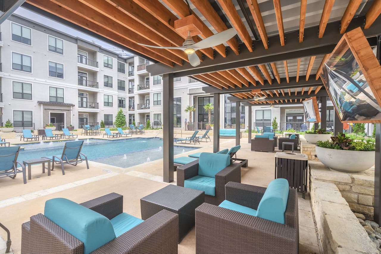Relaxing pool area with loungers at Seville Uptown Apartments