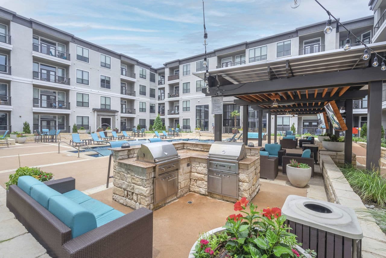 Outdoor grill area at Seville Uptown Apartments