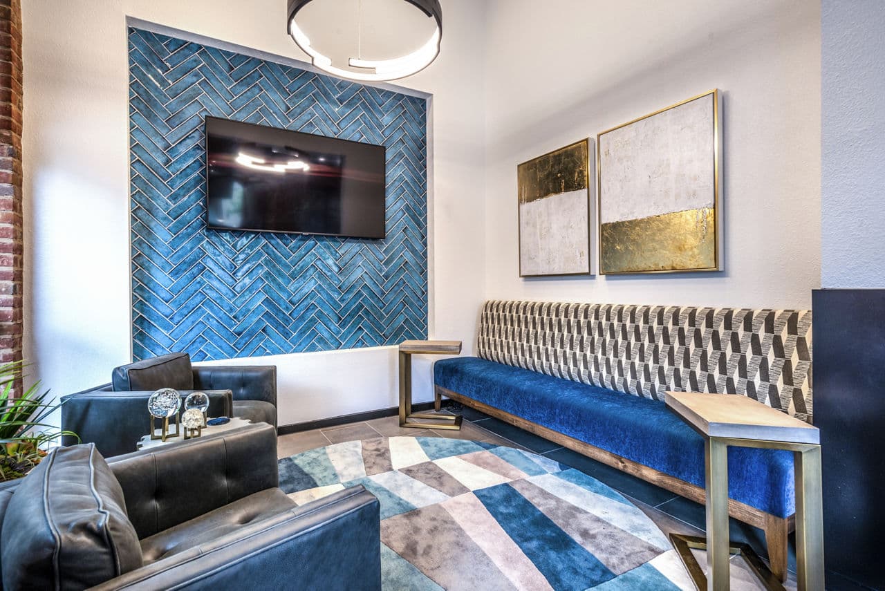 Clubhouse lobby featuring modern decor and seating at Manchester State Thomas Apartments