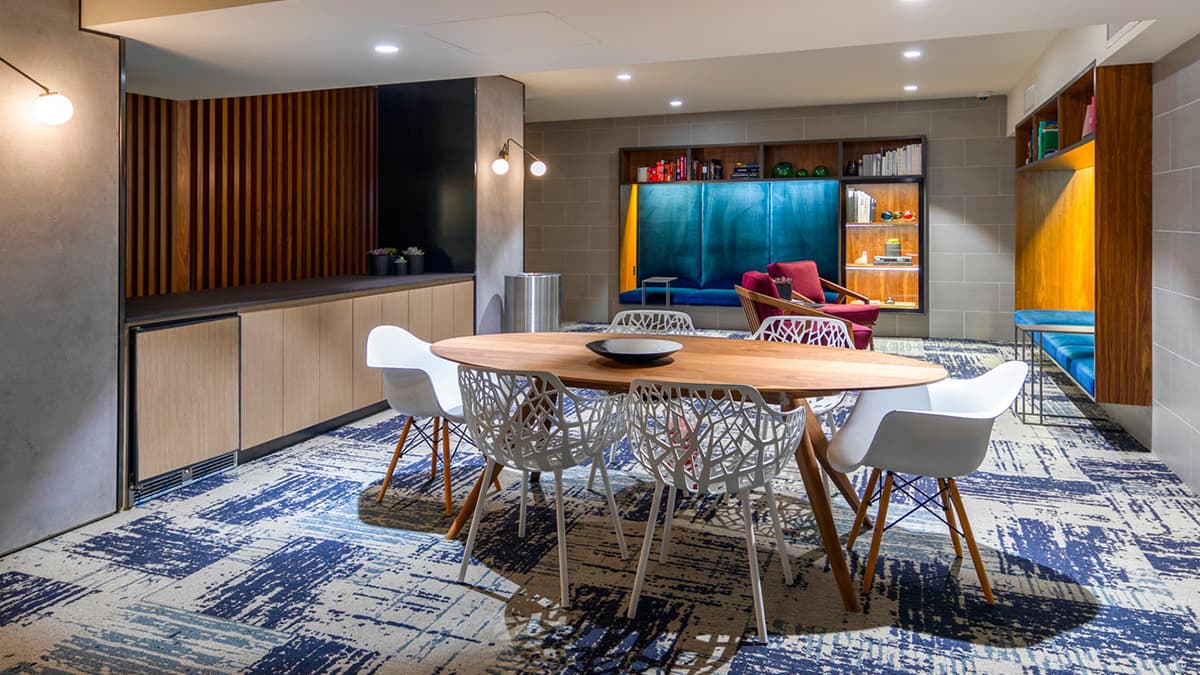 Lounge and Kitchenette area with mini fridge and table with modern style chairs and built-in seating