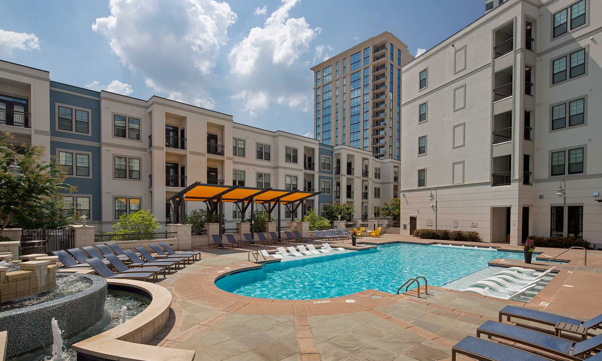 Pool with in-water and dry lounge seats, fountain and covered seating