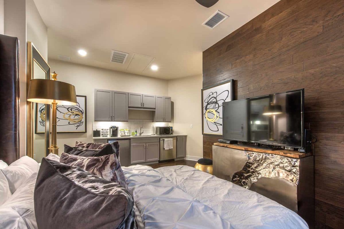 Guest suite bedroom with hardwood-inspired flooring