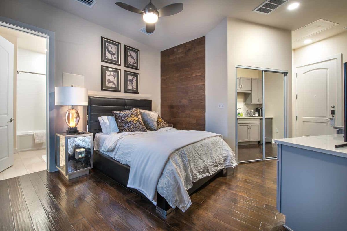 Guest suite bedroom with hardwood-inspired flooring