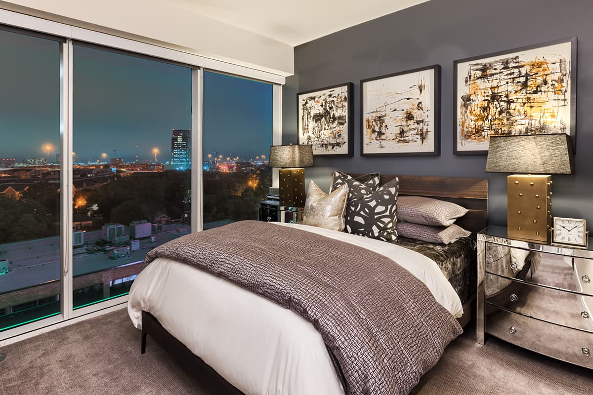 Cozy bedroom with expansive skyline views and plush carpet