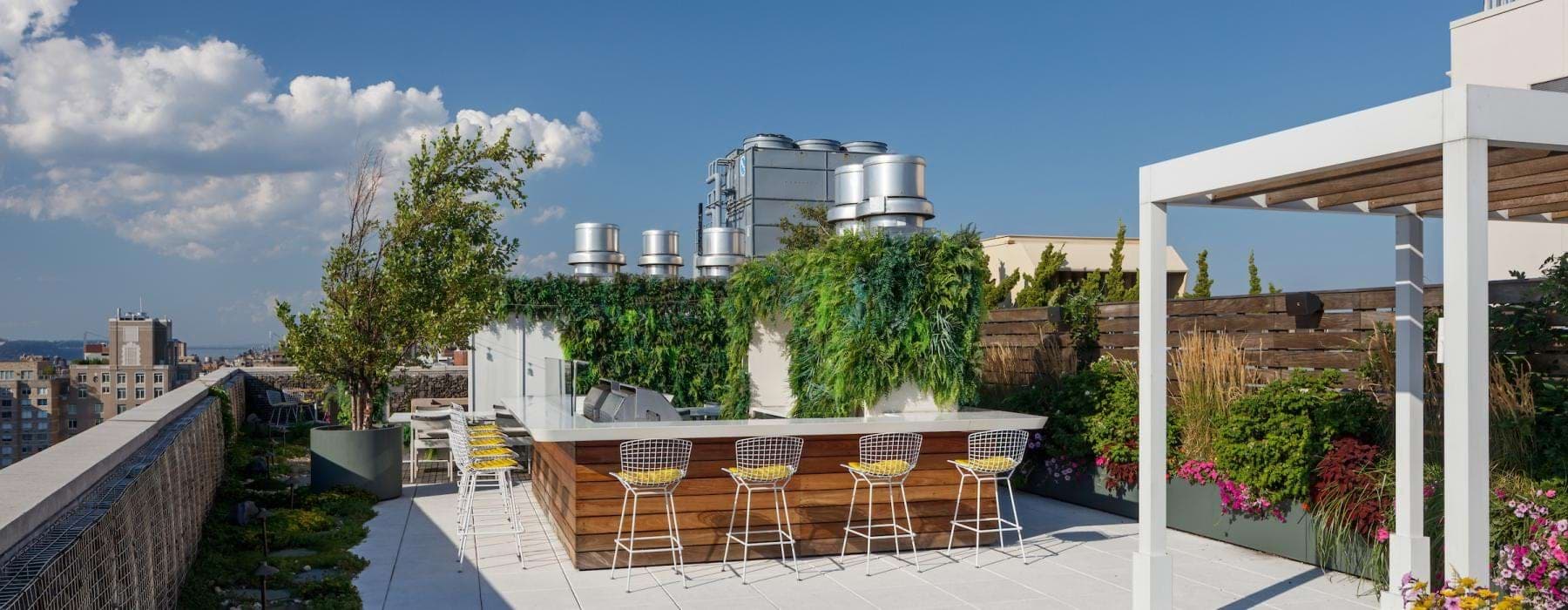 a patio with tables and chairs on it with a building in the background